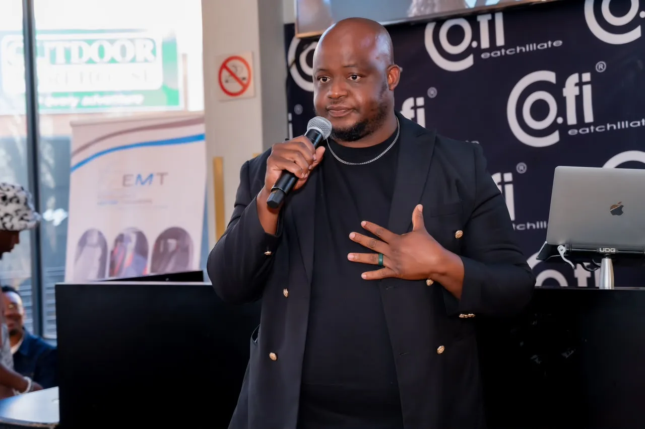 Oscar speaking at a corporate event in a black blazer